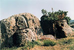A semicircular idol is carved on the rock on the left. The stepped altar can be seen in front of the rock on the right.